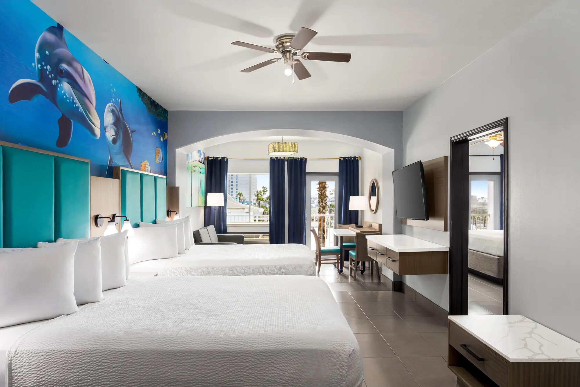 Two-Room Family Suite with Sofa, with a dolphin mural over the beds